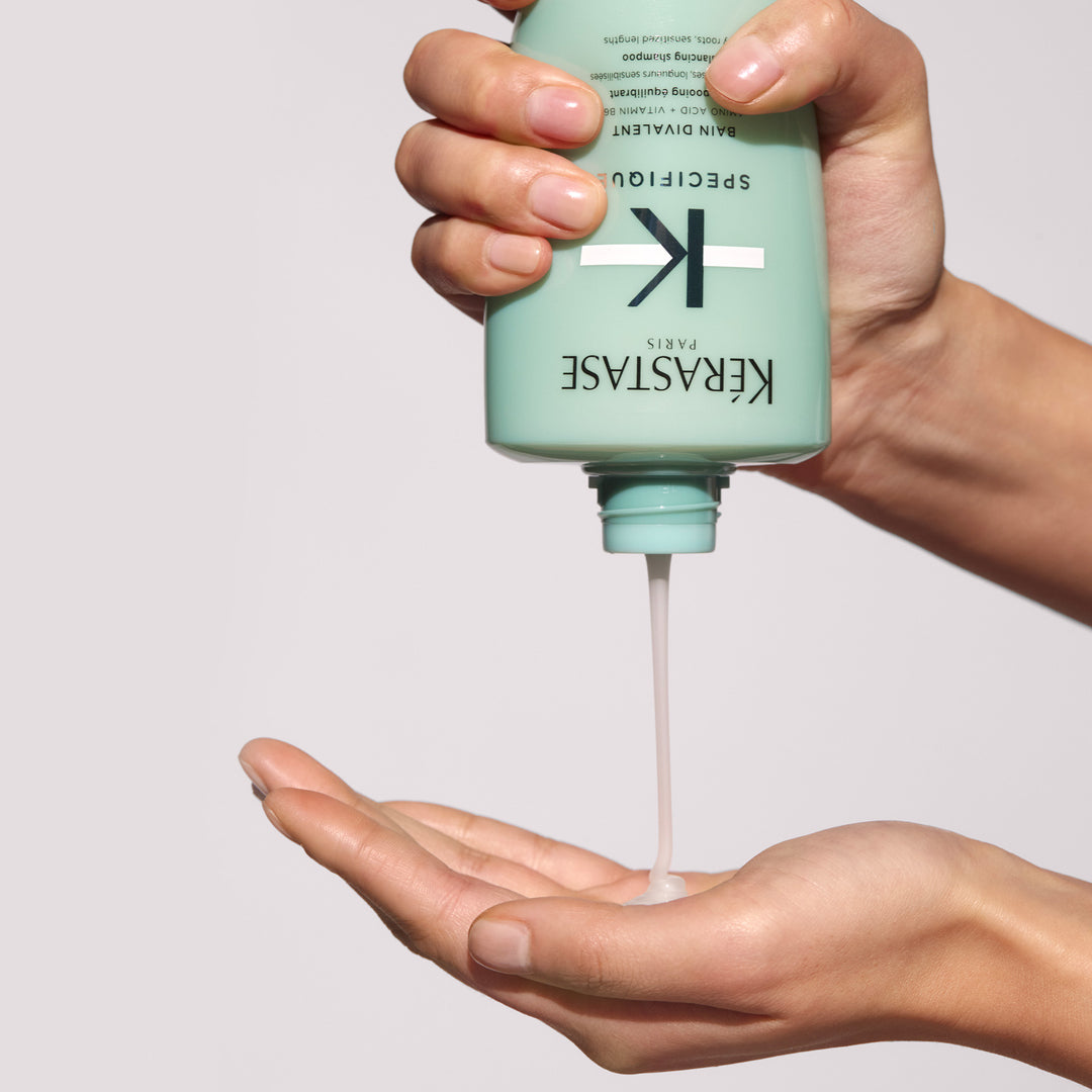 Kerastase Specifique Bain Divalent Balancing Shampoo product in hand