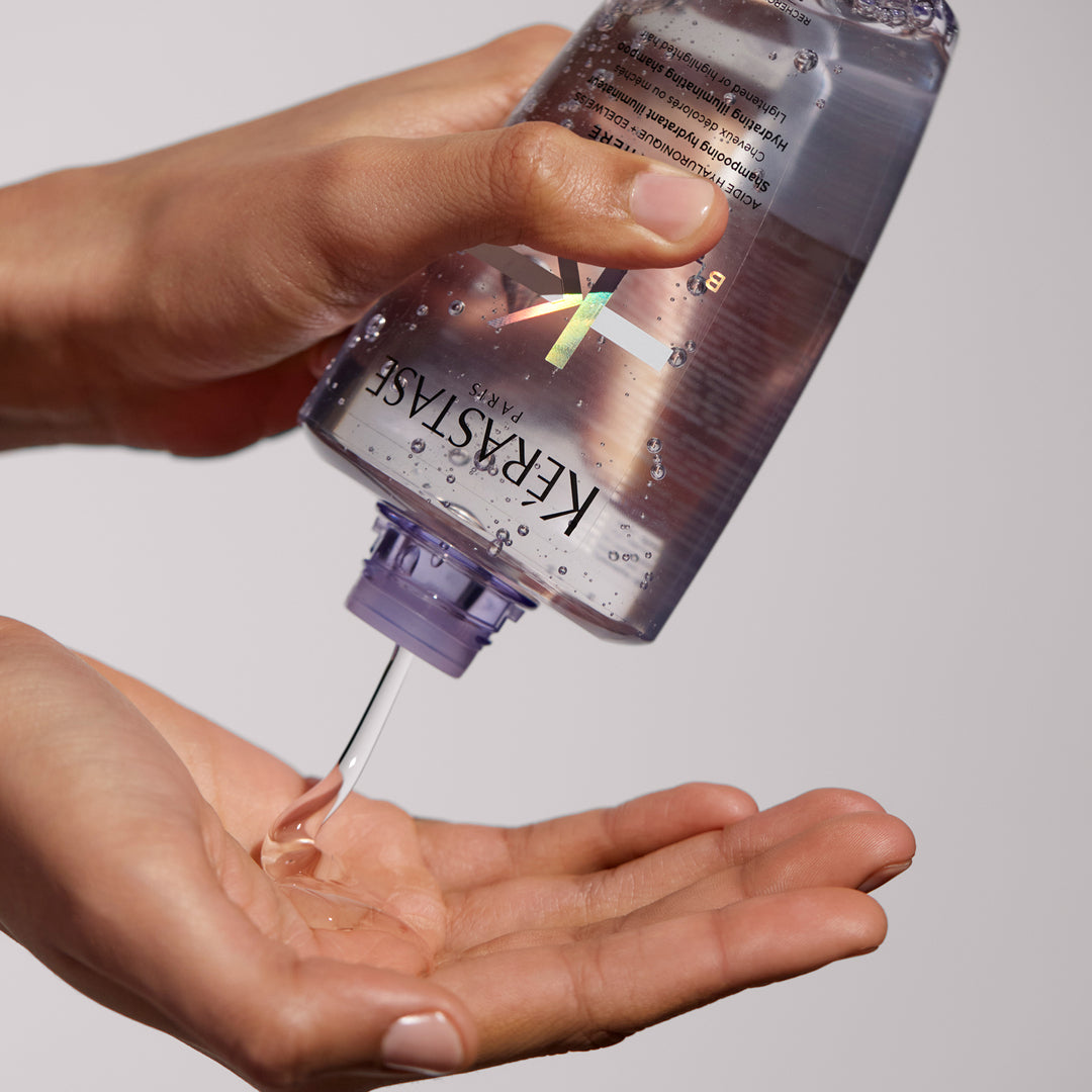 kerastase blond absolu bain lumiere shampoo product in hand